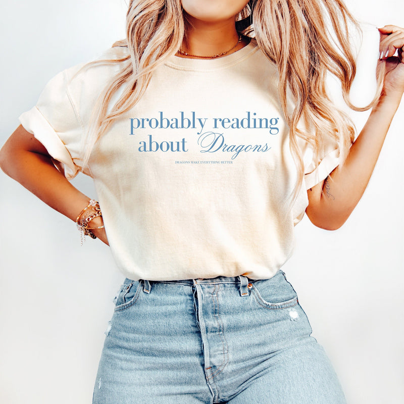 Show off your love for all things dragon-related with our "Probably Reading About Dragons" Shirt. Perfect for fantasy enthusiasts, this shirt combines comfort with a touch of whimsy, making it a must-have for your wardrobe.