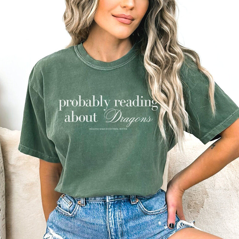 Show off your love for all things dragon-related with our "Probably Reading About Dragons" Shirt. Perfect for fantasy enthusiasts, this shirt combines comfort with a touch of whimsy, making it a must-have for your wardrobe.